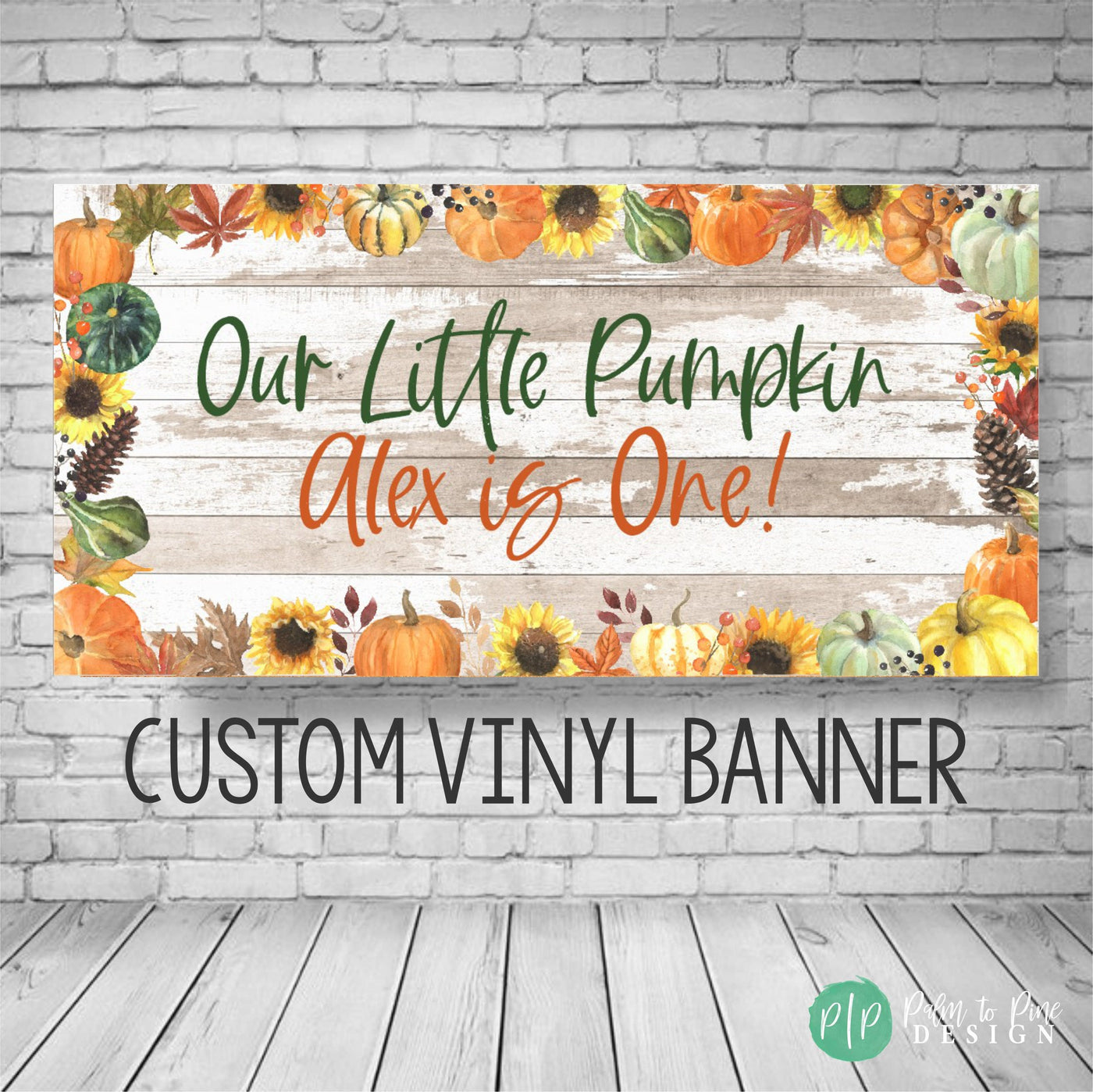 A custom vinyl banner with a rustic wood background and fall-themed decorations. The banner reads &#39;Our Little Pumpkin Alex is One!&#39; with sunflowers, pumpkins, and fall leaves. The text &#39;CUSTOM VINYL BANNER&#39; is printed below the design.