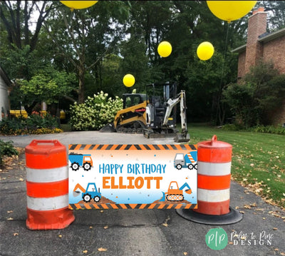 blue and orange construction birthday banner with construction equipment and caution tape