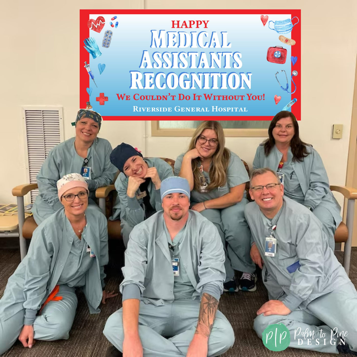 A group photo of seven medical assistants in light teal scrubs, smiling in front of a banner that says &#39;Happy Medical Assistants Recognition. We Couldn&#39;t Do It Without You! Riverside General Hospital.&#39;  The banner has medical-themed icons. The medical assistants are sitting on a beige couch.  The photo is well-lit and has a professional feel.