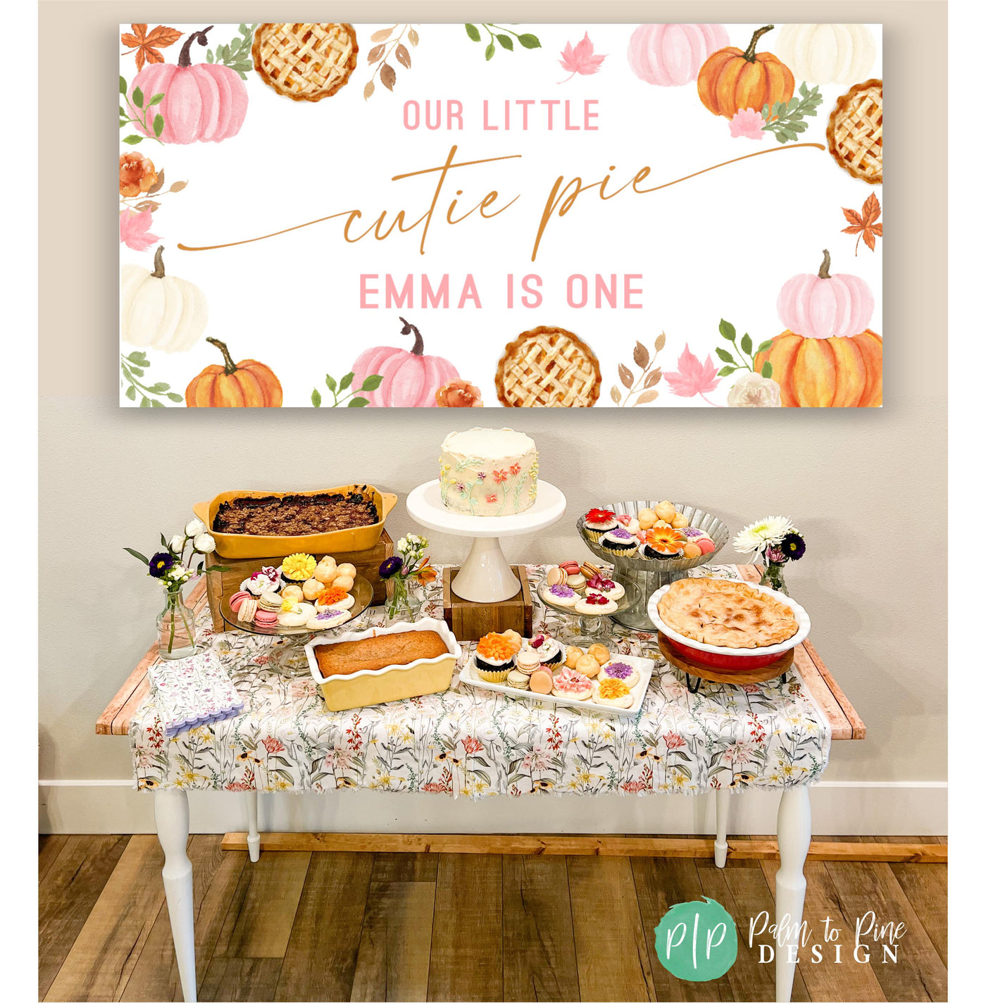 Little Cutie Pie Pumpkin Birthday Banner behind a fall themed dessert table with pies, crisps and floral cupcakes