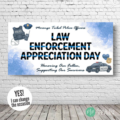 Law Enforcement Appreciation Day banner hung against a plain wall, featuring bold black and blue text with watercolor police gear and thin blue line elements, including a badge, patrol car, and heart
