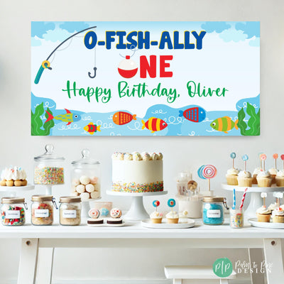 Big One fishing themed banner in front of dessert table with colorful display