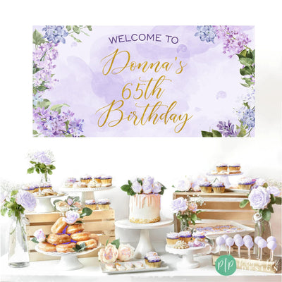 Purple birthday banner with watercolor lilac flowers, perfect for a feminine adult celebration in front of dessert table