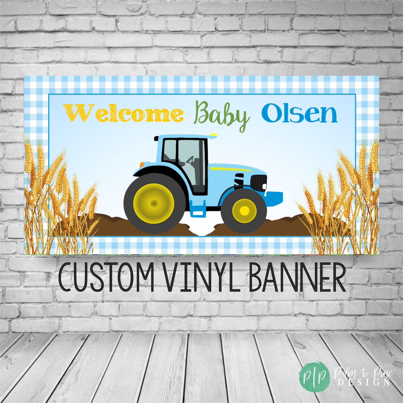 Blue tractor baby shower banner with blue gingham border, golden wheat accents, and Welcome Baby text