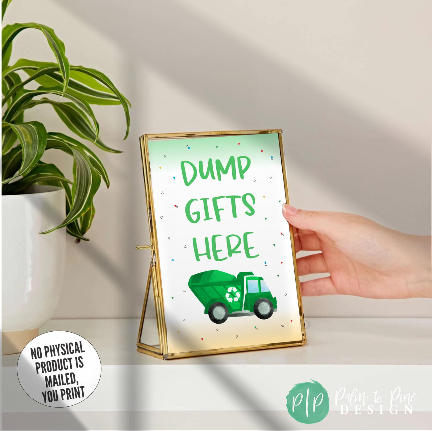 Dump Gifts Here party sign for transportation party in gold frame being placed on shelf