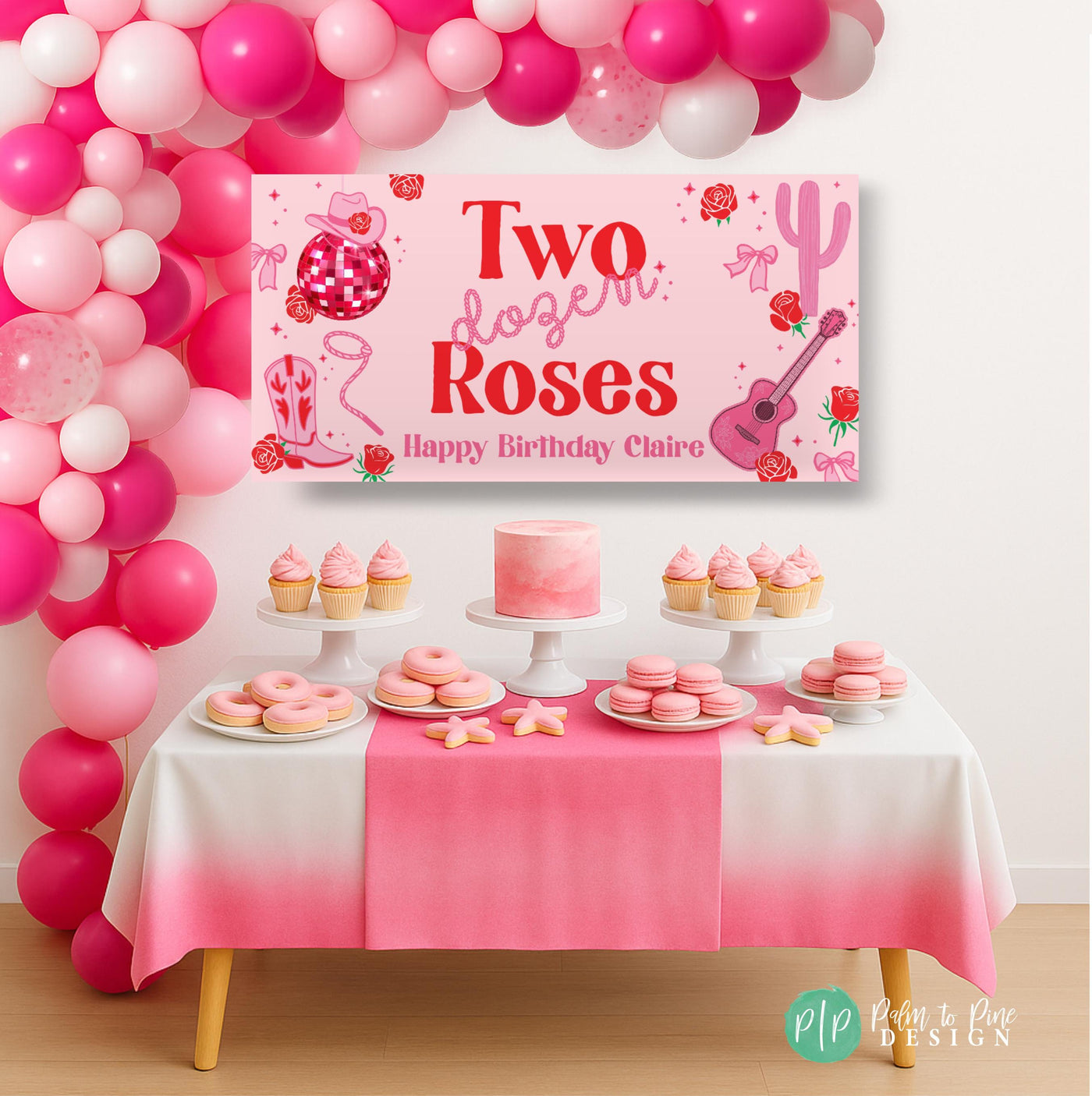 Two Dozen Roses birthday banner in pink and red hung above a dessert table with cupcakes and treats, featuring cowgirl and rope fonts, disco ball, roses, guitar, cactus, and western icons