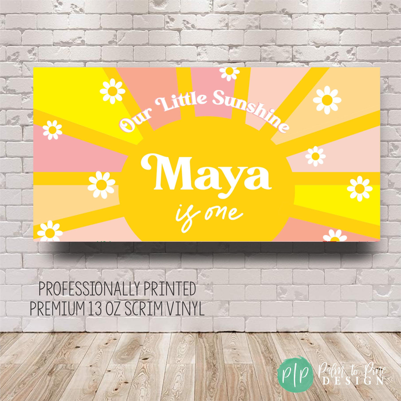Sun and daisy themed Our Little Sunshine banner in yellow, pink, and tan with birthday girl’s name, displayed on a simple wall backdrop