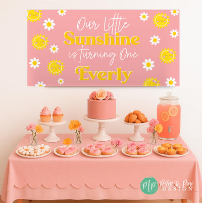 Groovy daisy banner hanging above a cake and cupcakes on a pink dessert table.