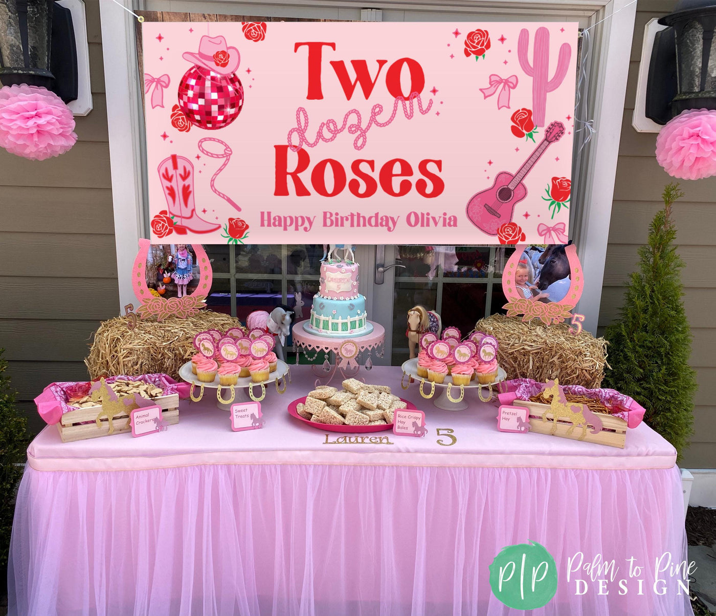 Girls’ Two Dozen Roses party banner in western cowgirl font displayed behind a pink and red birthday dessert table, decorated with cowgirl hats, boots, and roses