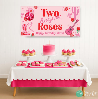 Western-themed Two Dozen Roses birthday banner in pink and red staged above a dessert table with birthday treats, accented by cowgirl and rope lettering and disco ball, cactus, and guitar details