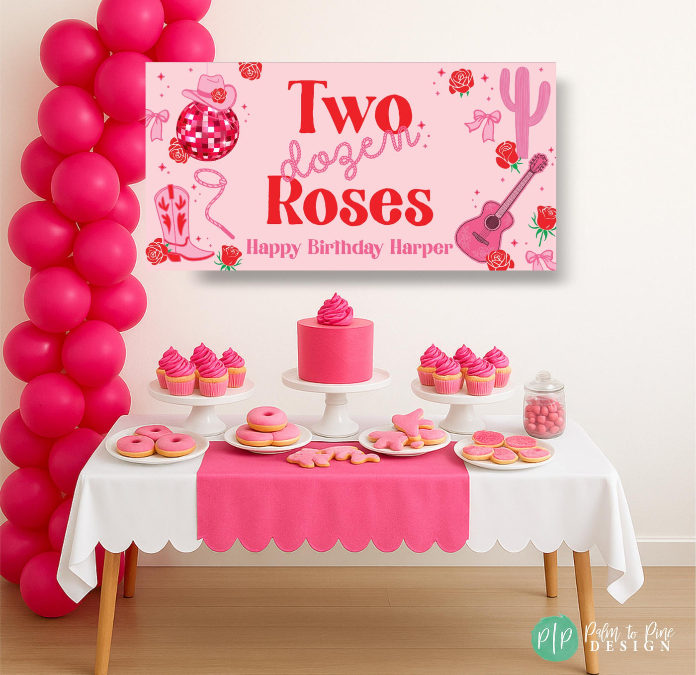 Pink and red Two Dozen Roses birthday banner featuring western and rope fonts, cowgirl and musical icons, displayed behind a themed dessert table for a girls’ birthday party.