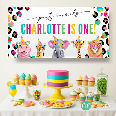 Personalized Party Animals banner with hippo, cheetah, elephant, giraffe, and lion in party hats, styled with rainbow leopard border at a kids jungle safari birthday celebration
