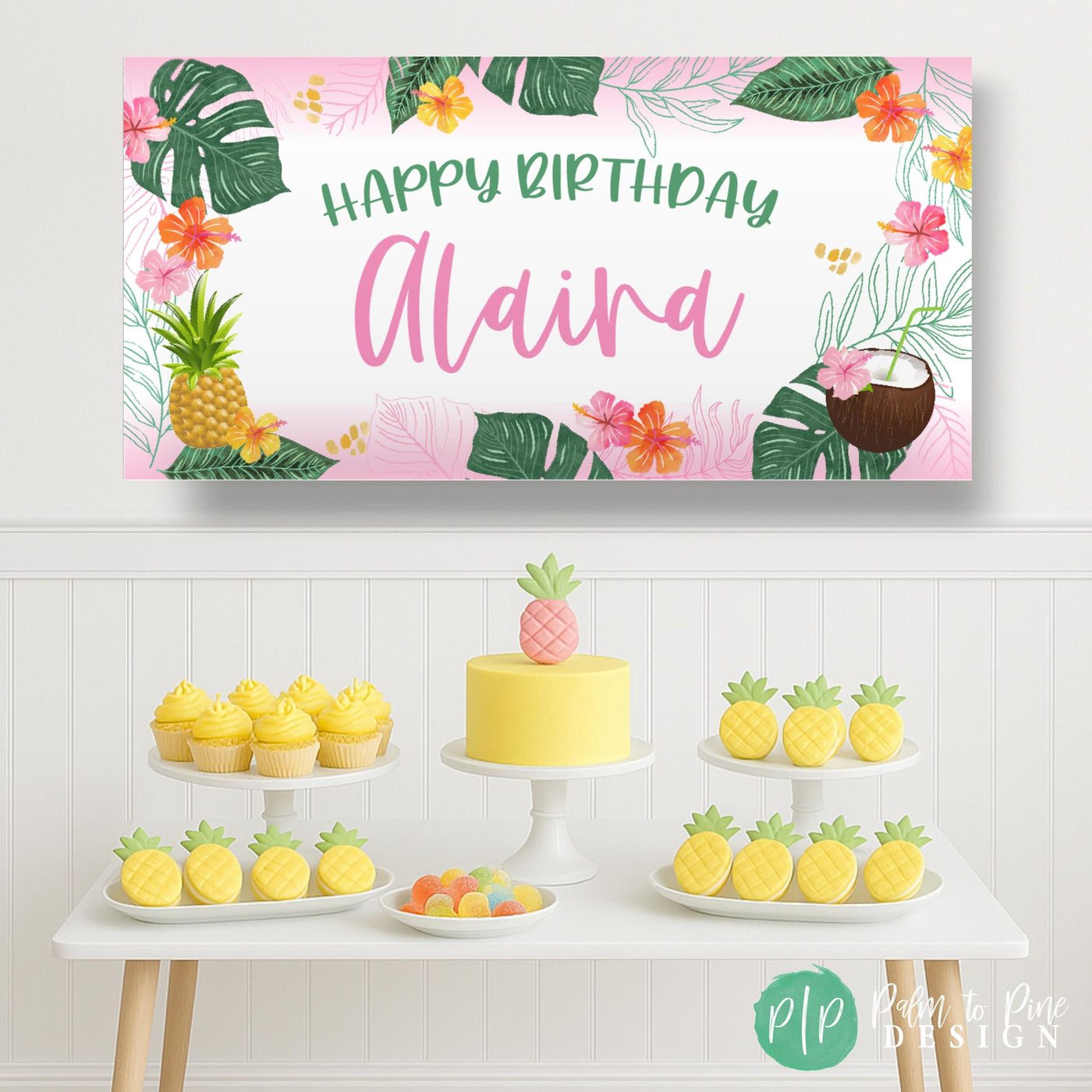 Tropical birthday dessert table with pink and green banner featuring palms, pineapples, and flowers.