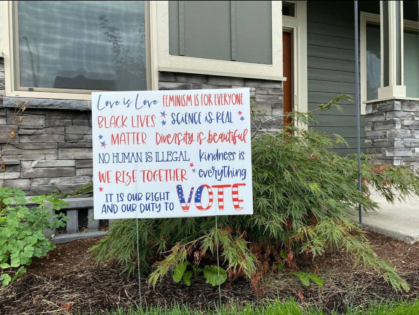 In this House yard sign